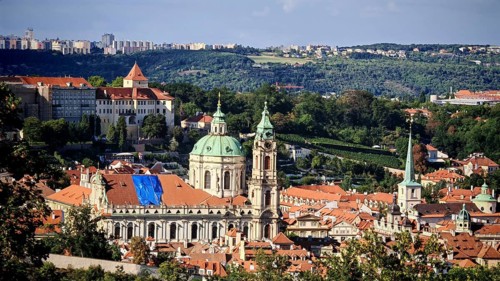 View of a Baroque church and surrounding cityscape with sunny sky, Prague, Czech Republic