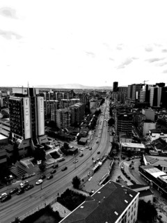 Black and white city view with modern buildings and sustained road traffic, Pristina, Kosovo
