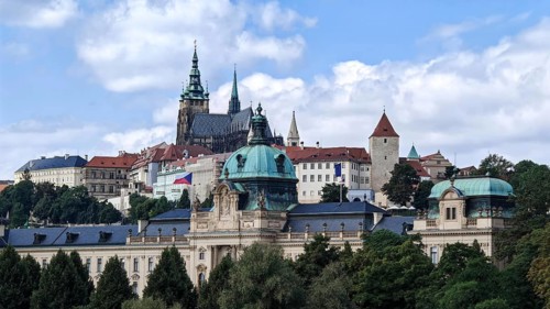 Historic buildings and towers under blue sky in an urban landscape, view of Hradcany, Prague Czech
