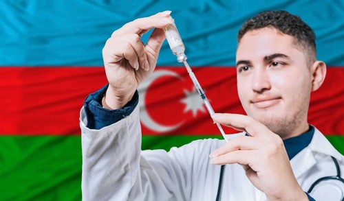Doctor holding syringe on Azerbaijan flag background. Medical professional holding syringe with