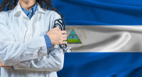 Healthcare professional with Nicaragua flag background. Professional doctor holding stethoscope on
