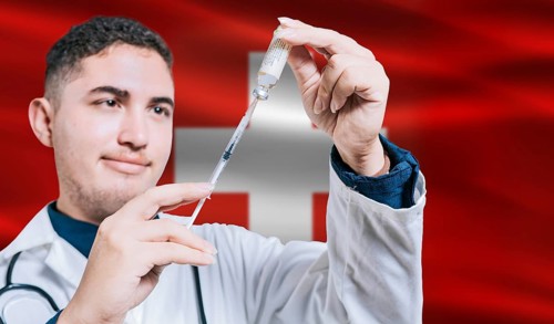 Doctor holding syringe on Switzerland flag background. Medical professional holding syringe with