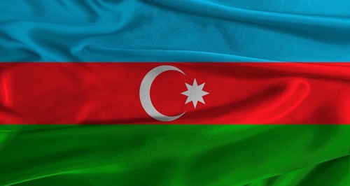 Flag of Azerbaijan with fabric textured background. Close up of National flag of Azerbaijan with