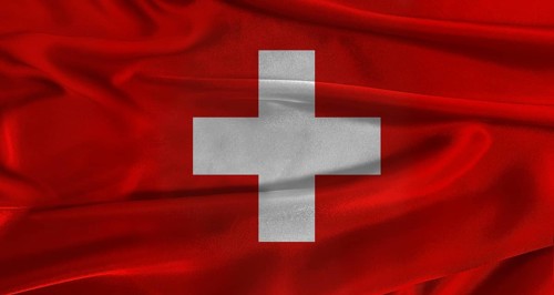 Flag of Switzerland with fabric textured background. Close up of National flag of Switzerland with