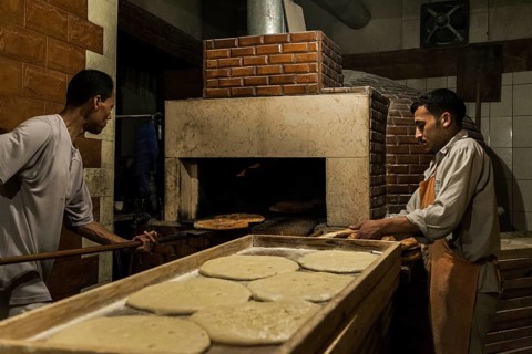 Tripoli, Libya, North Africa. Making traditional pita bread in an old bakery in the historic part
