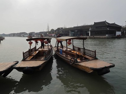 Two traditional boats with lanterns anchor on a quiet river in a Chinese city, Zhujiajiao Ancient