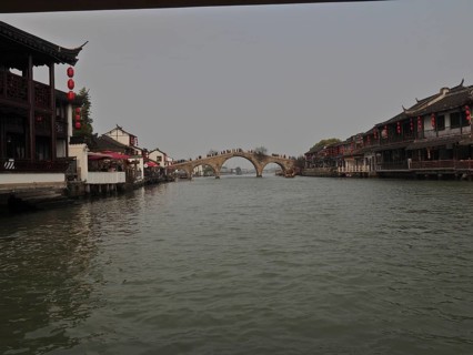 Traditional Chinese architecture on a quiet river with bridge under cloudy sky, Zhujiajiao Ancient
