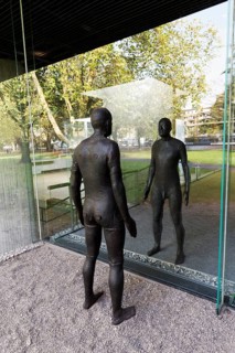 Male figure looking at her real reflection, Reflections II sculpture by sculptor Antony Gormley,