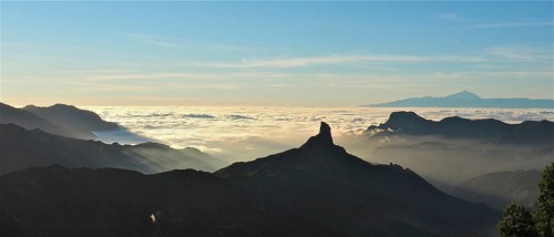 Unique mountain silhouette at sunset over a sea of clouds, Roque Nublo, Gran Canaria, Canary