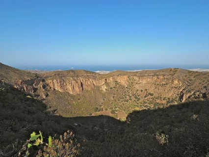 Caldera de Bandama volcanic crater overlooking the sea under a blue sky, Gran Canaria, Canary