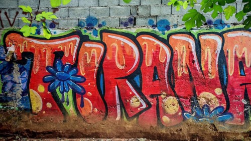 Graffiti with eye-catching colorful letters on a wall in an urban environment, city name Tirana,