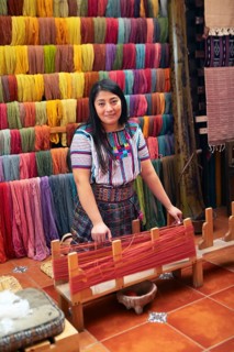Maya woman, 42 years old, working on a weaving frame, traditional crafts in a woman's cooperative,