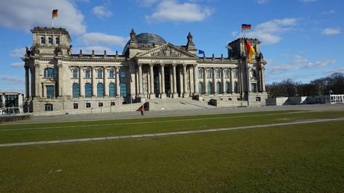 Historic building, Reichstag, Bundestag with dome and German flags on a sunny day, without people,