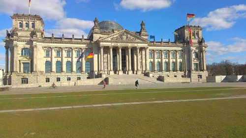 The Reichstag building in Berlin under a clear, blue sky, deserted, without people during corona,