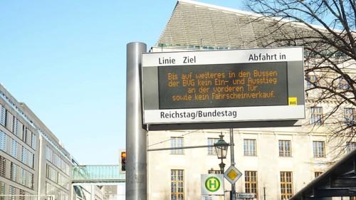 Bus stop with digital information sign in the city, sign during corona, Berlin