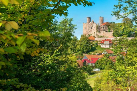 View of the ruins of Hanstein Castle and the small village of Rimbach with half-timbered houses,