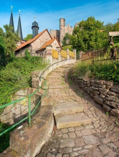 Narrow steep alleyway with cobblestones in the small village of Rimbach below the ruins of Hanstein