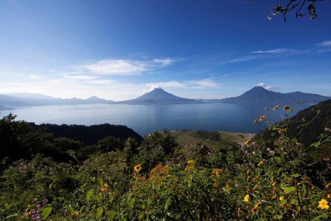 Lake Atitlán or Lake Atitlán in the morning, in the back the volcanoes San Pedro, Atitlán and