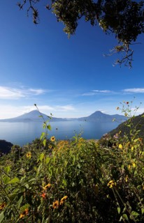 Lake Atitlán or Lake Atitlán in the morning, in the back the volcanoes San Pedro, Atitlán and