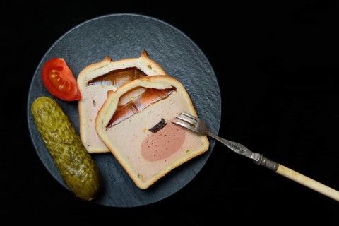 Battered pate on plate with cucumber and tomato