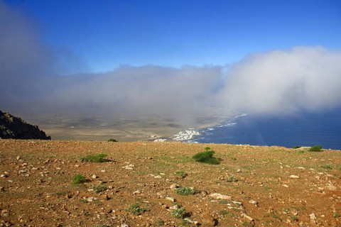 Wide view from Mirador de Ermita de Las Nieves of the coastal village of Caleta de Famara with