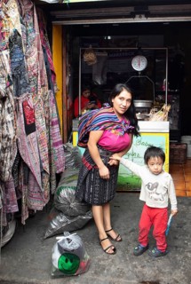 Mayan woman with toddler in traditional clothes at the market in Chichicastenango, Highlands, El