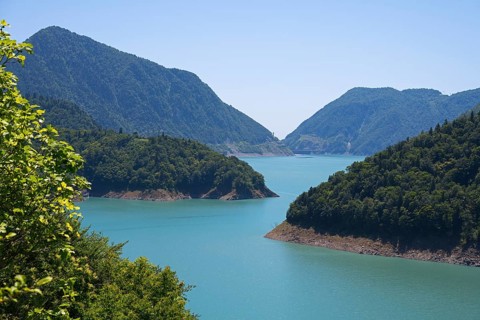 Large, calm lake surrounded by forested mountains, Jvari Reservoir, Enguri River, Mingrelia region