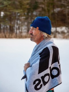 Man with cap, 55, standing on the ice wrapped in a towel after ice bathing, Thumsee, Bad