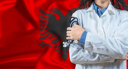 Healthcare professional with Albania flag background. Professional doctor holding stethoscope on