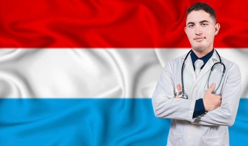 Portrait of medical professional on Luxembourg flag background. Luxembourgish national health