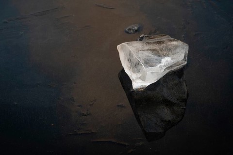 Piece of ice lies on the frozen surface of a lake, Finland