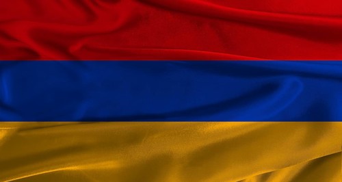 Flag of Armenia with fabric textured background. Close up of National flag of Armenia with