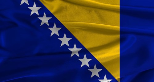 Flag of Bosnia and Herzegovina with fabric textured background. Close up of National flag of Bosnia