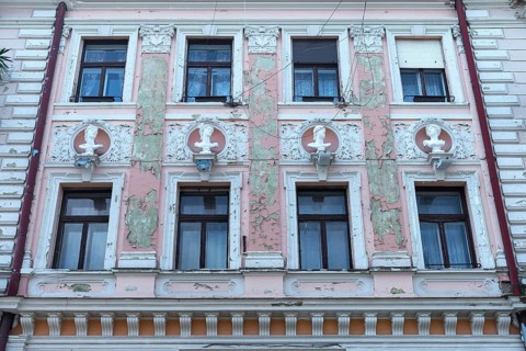 Dilapidated house façade with busts from Greek mythology, Czernowicz, Ukraine
