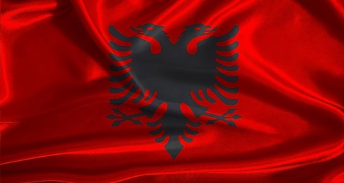 Albania flag with cloth textured background. National flag of Albania with realistic texture