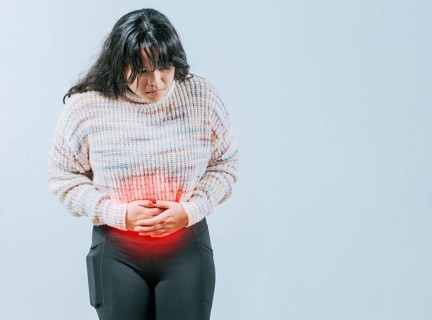 Female person holding stomach with digestive problems isolated. Sore Asian woman with digestive