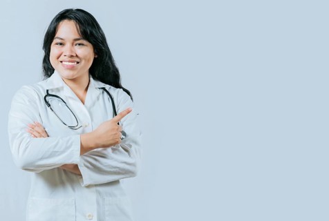Smiling asian female doctor recommending an advertisement. Asian young doctor pointing to the side