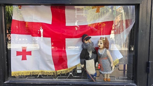 Shop window with traditional Georgian dolls and flag, Georgia