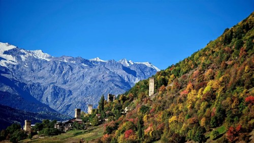 Mountain landscape with thick forests and medieval towers in autumn, Mestia, Georgia