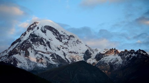Majestic snow-covered mountain under cloudy sky, Kazbek, Stepantsminda, Georgia