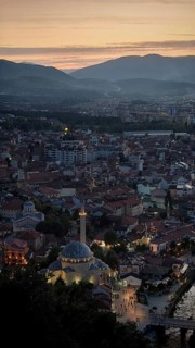 A view of the city at dusk dominated by a mosque and surrounded by mountains, Prizren, Kosovo
