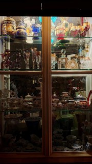 Showcase with illuminated decorative glassware and antiques, Prague, Czech Republic