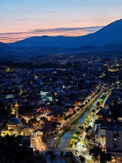 Nighttime city view with illuminated river and adjacent architecture, Prizren, Kosovo
