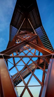View of a metallic observation tower with geometric shapes under a blue sky, Pressecker Knock,