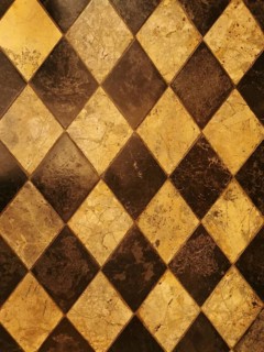 Checkerboard pattern of brown and yellow marble tiles