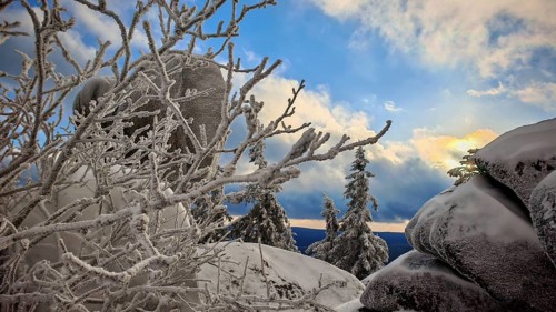 Snowy rocks and trees with a dramatic evening sky, Fichtelgebirge, Bavaria