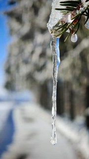 Close-up of a long icicle against a blurred background, Fichtelgebirge, Bavaria