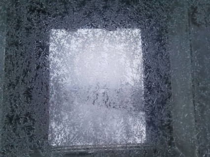 An icy window with frosty structures that give off a cold winter feeling, Franconian Forest nature