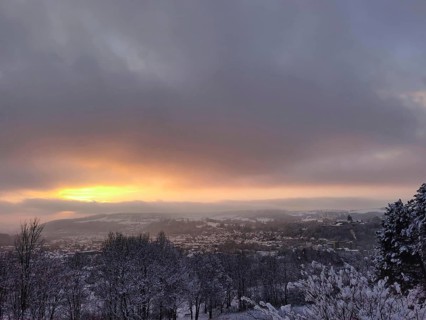 Snowy cityscape with golden sunset