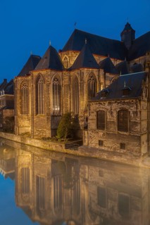 Ghent, Belgium, Flanders. A historic church with reflections in a canal